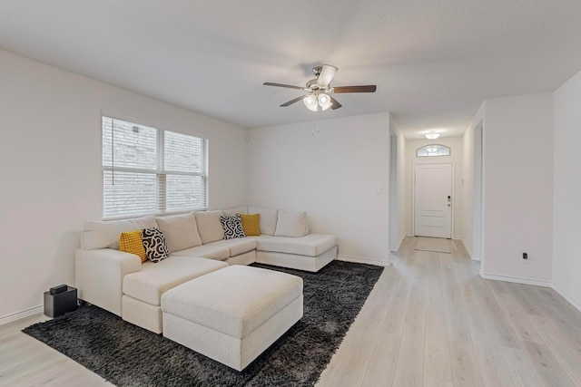 living room featuring light wood-type flooring and ceiling fan