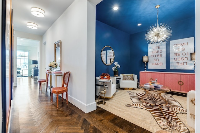 living area featuring a chandelier and parquet floors