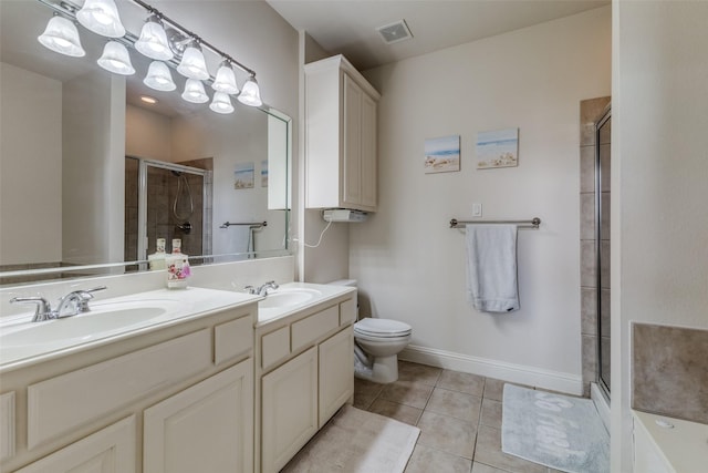 bathroom featuring tile patterned floors, vanity, toilet, and an enclosed shower