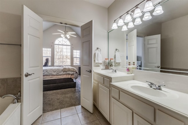 bathroom featuring ceiling fan, a washtub, tile patterned floors, vaulted ceiling, and vanity