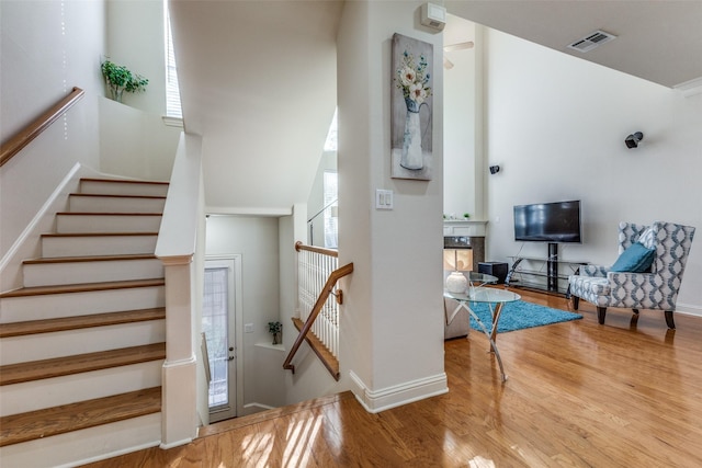 stairway featuring a fireplace and wood-type flooring