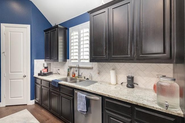 kitchen featuring dishwasher, sink, dark wood-type flooring, backsplash, and vaulted ceiling