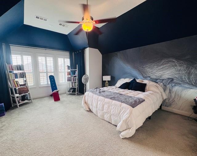 bedroom with vaulted ceiling, carpet flooring, and ceiling fan