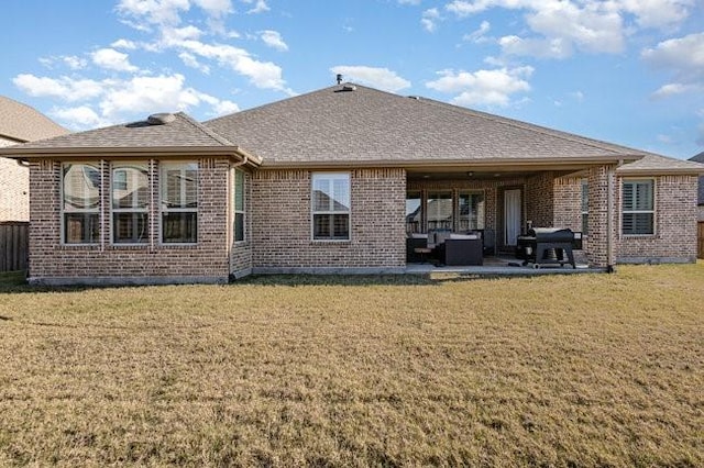 rear view of house featuring a yard and a patio area