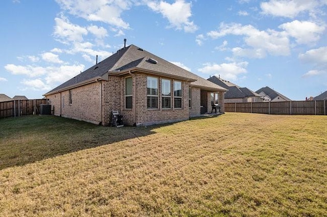 rear view of property featuring a yard