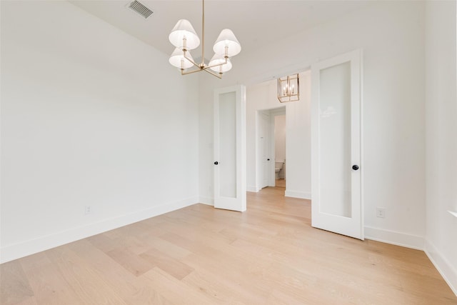 3231 Fisher Rd, Rockwall, TX 75032 - empty room featuring a chandelier, light wood-type flooring, and baseboards