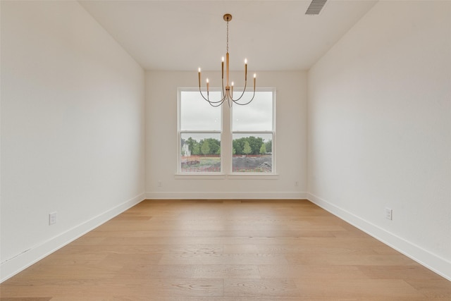 3231 Fisher Rd, Rockwall, TX 75032 - spare room featuring a chandelier, light wood-type flooring, and baseboards