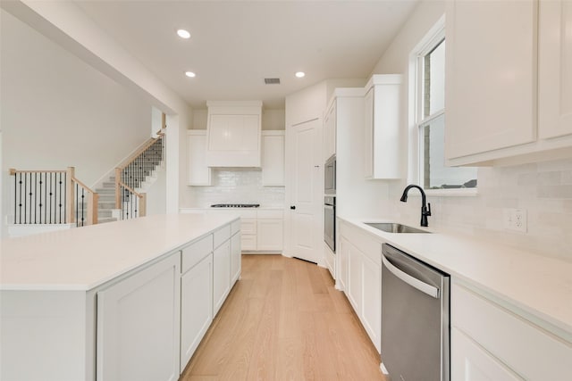 3231 Fisher Rd, Rockwall, TX 75032 - kitchen featuring black appliances, a sink, tasteful backsplash, light wood-style flooring, and recessed lighting