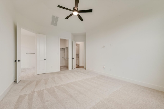 3231 Fisher Rd, Rockwall, TX 75032 - unfurnished bedroom featuring a walk in closet, light colored carpet, ensuite bathroom, and baseboards