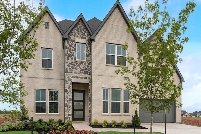 3231 Fisher Rd, Rockwall, TX 75032 - tudor-style house with concrete driveway, brick siding, and a garage