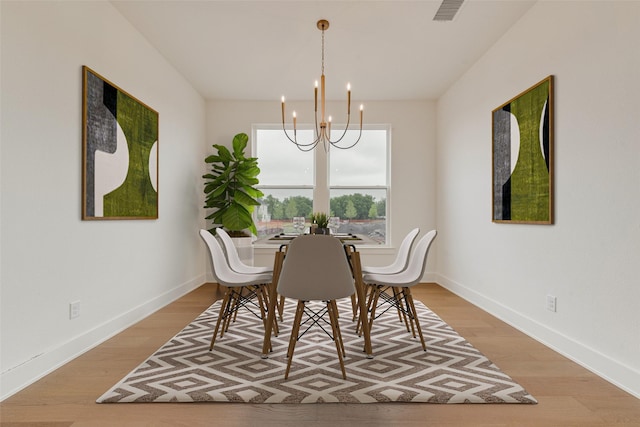 3231 Fisher Rd, Rockwall, TX 75032 - dining area with a chandelier, light wood finished floors, and baseboards
