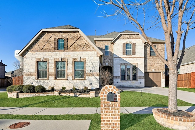 view of front of home with a front lawn and a garage