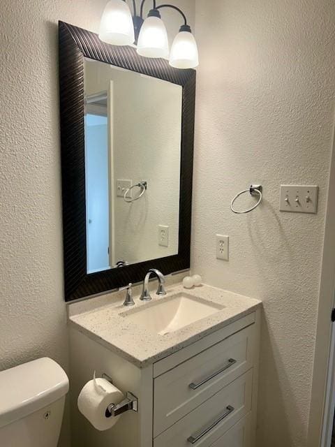 bathroom with toilet and vanity