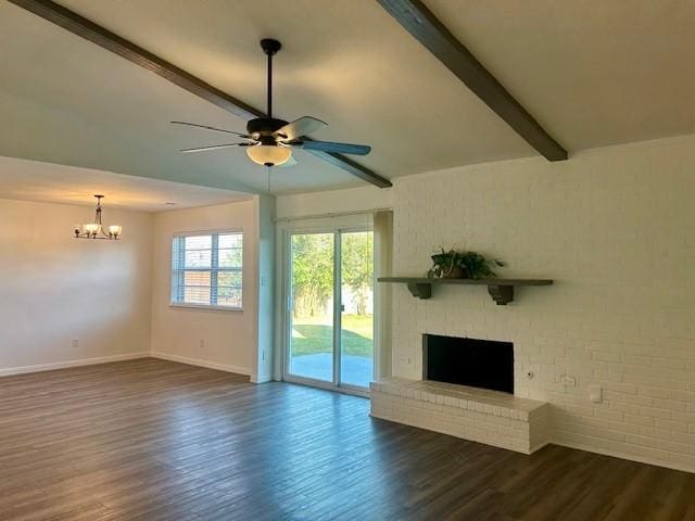 unfurnished living room featuring a brick fireplace, ceiling fan with notable chandelier, dark hardwood / wood-style floors, and vaulted ceiling with beams