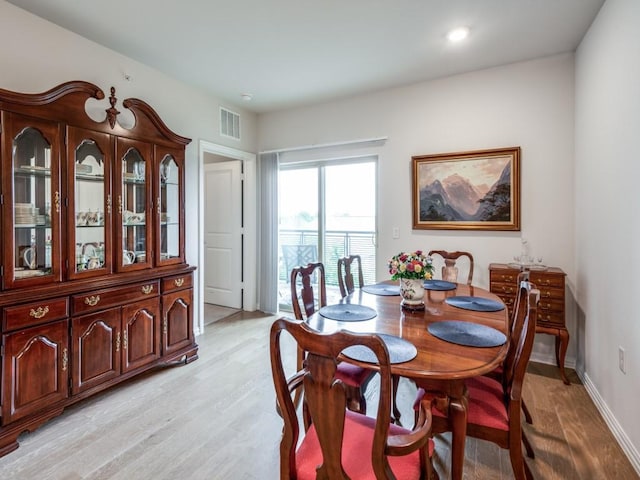 dining space with light wood-type flooring