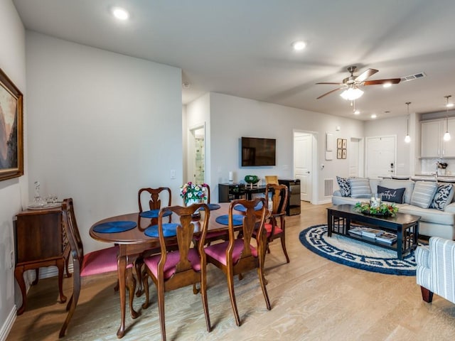 dining room featuring light hardwood / wood-style floors and ceiling fan