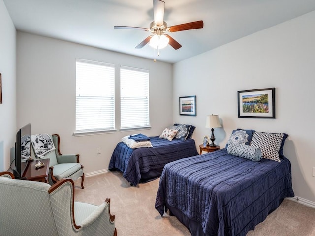 bedroom with light colored carpet and ceiling fan