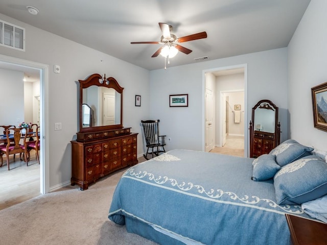 carpeted bedroom with ceiling fan and ensuite bathroom