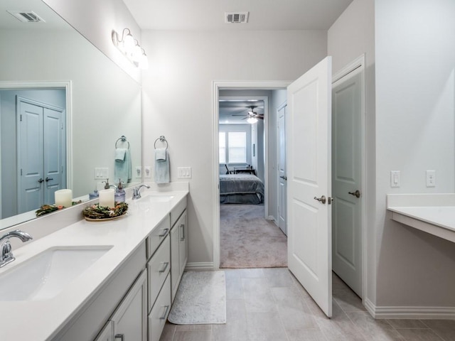 bathroom with tile patterned flooring, vanity, and ceiling fan