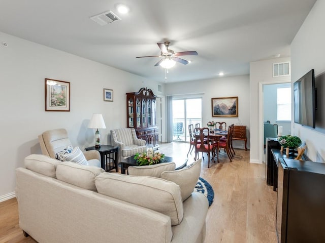 living room featuring ceiling fan and light wood-type flooring