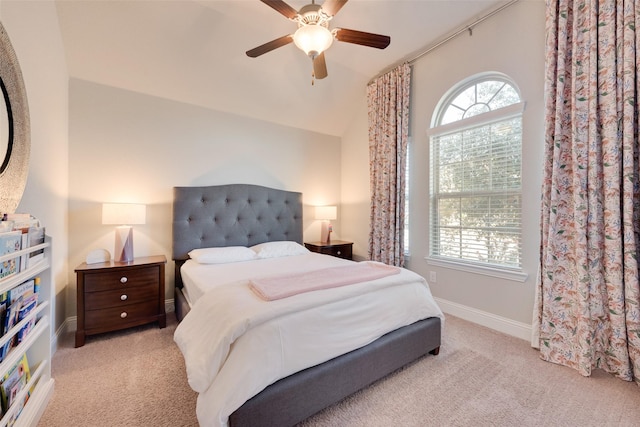 bedroom with ceiling fan, light carpet, and vaulted ceiling