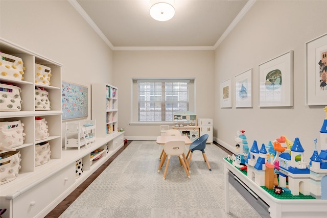 rec room with hardwood / wood-style floors and crown molding