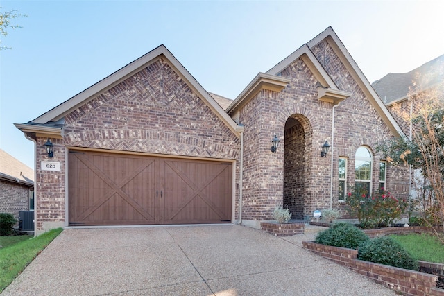 view of front of home with cooling unit and a garage