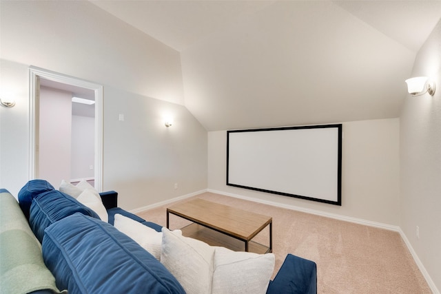 home theater with light colored carpet and vaulted ceiling