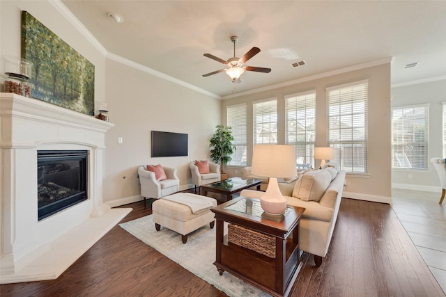 living room with ceiling fan, dark hardwood / wood-style flooring, and ornamental molding