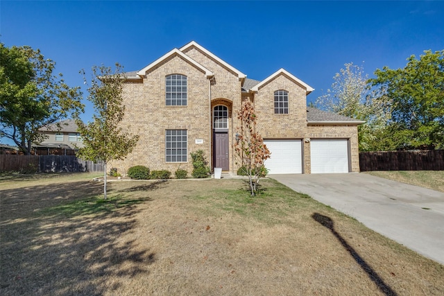 view of front of property featuring a front yard and a garage