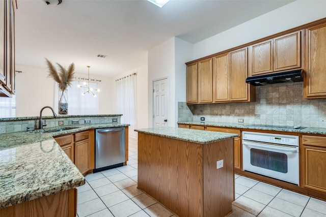 kitchen with a center island, decorative light fixtures, oven, stainless steel dishwasher, and sink