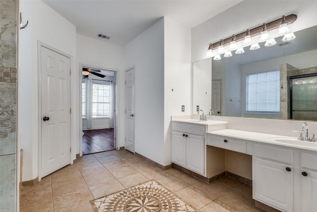 bathroom with ceiling fan, tile patterned floors, walk in shower, and vanity