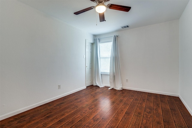 empty room with ceiling fan and dark wood-type flooring