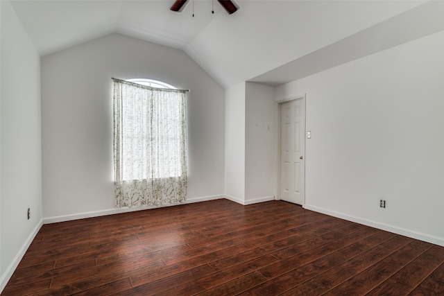 empty room with ceiling fan, dark wood-type flooring, and vaulted ceiling