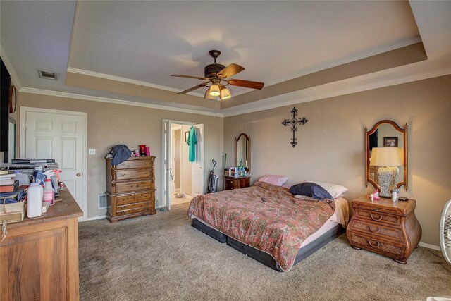 bedroom with carpet, a tray ceiling, ceiling fan, and ensuite bathroom