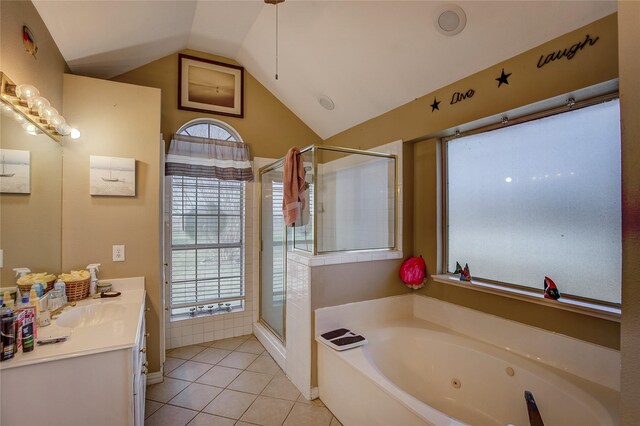 bathroom featuring tile patterned flooring, vanity, independent shower and bath, and vaulted ceiling