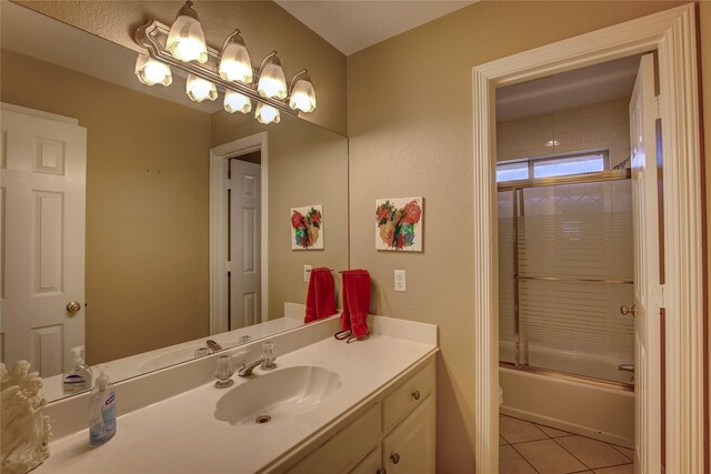 bathroom with shower / bath combination with glass door, tile patterned flooring, and vanity