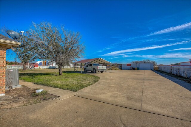 view of yard featuring a carport and an outdoor structure