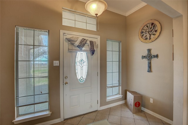 tiled foyer featuring ornamental molding