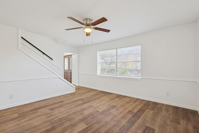 unfurnished living room with ceiling fan and wood-type flooring