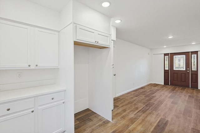 kitchen with white cabinets and light wood-type flooring