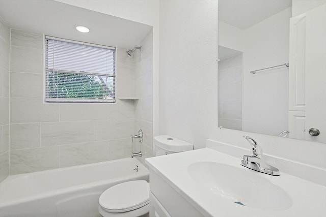 full bathroom with tiled shower / bath combo, toilet, and vanity