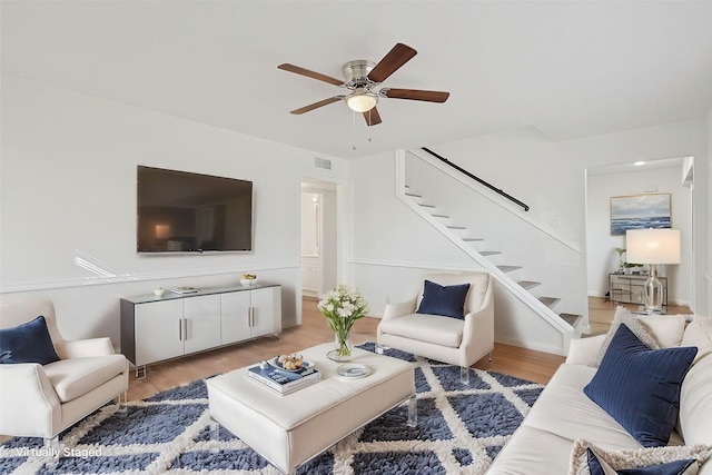 living room with ceiling fan and light wood-type flooring