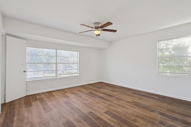 spare room with ceiling fan and dark hardwood / wood-style flooring