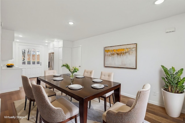 dining space with dark hardwood / wood-style floors