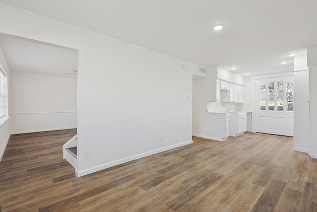 unfurnished living room with hardwood / wood-style floors