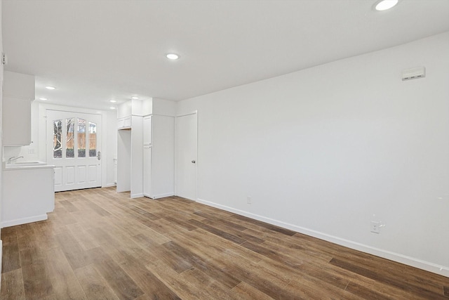 empty room with light wood-type flooring and sink