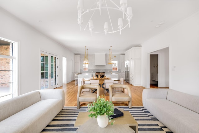 living room featuring light hardwood / wood-style flooring and a chandelier