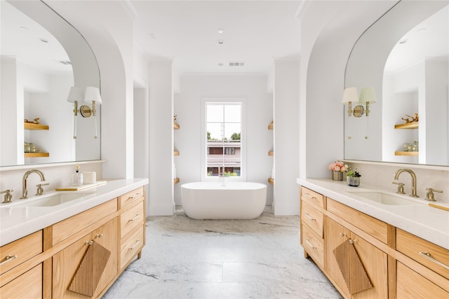 bathroom featuring vanity, crown molding, and a bathing tub