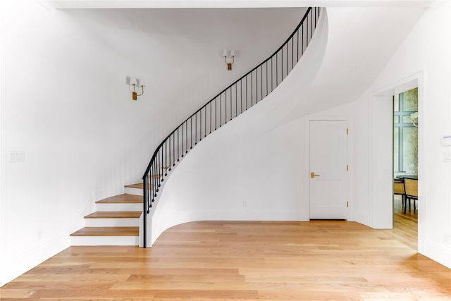 stairs with hardwood / wood-style flooring